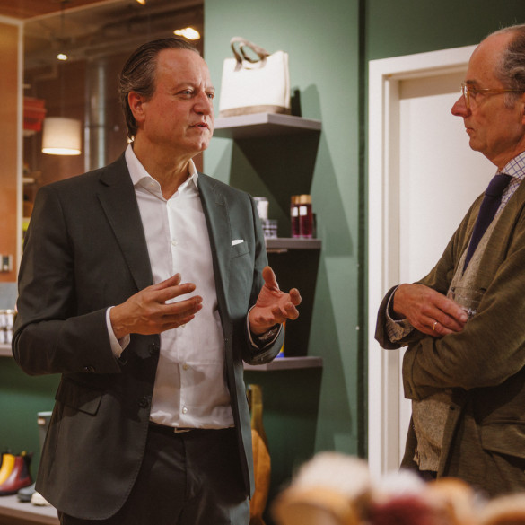Udo Robakowski im Gespraech mit Bernhard Roetzel im Ladengeschaeft von Schuh Konzept in Berlin, im Hintergrund Regale mit Pflegemitteln und eine Ausputzmaschine